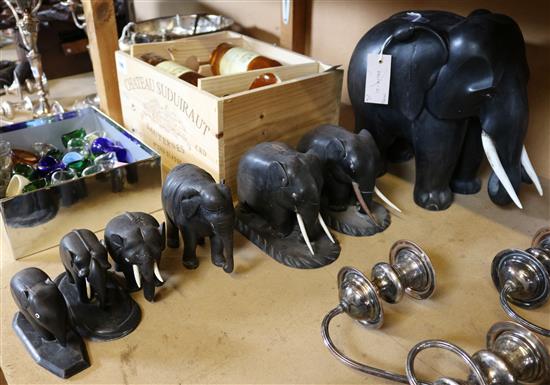 A harlequin set of seven Indian ebony elephants, largest 12in.